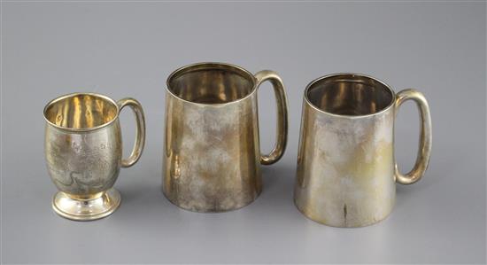 A pair of George V silver mugs, William Hair Haseler, Birmingham, 1935/7, height 85mm and one other smaller silver mug, 12.5oz,